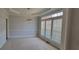 Neutral dining room with a tray ceiling, large windows with wooden shutters, and plush carpet at 3302 Fieldwood Se Dr, Smyrna, GA 30080