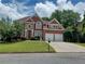 Charming two-story brick home with manicured lawn, a two-car garage and striking red shutters at 3302 Fieldwood Se Dr, Smyrna, GA 30080