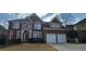 Charming brick home with a two-car garage, red shutters, and beautifully designed architectural details at 3302 Fieldwood Se Dr, Smyrna, GA 30080