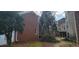 Exterior shot of the house showing brick facade, some AC units, landscaping and drainage system on the side of the building at 3302 Fieldwood Se Dr, Smyrna, GA 30080