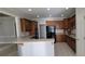 Spacious kitchen with wood cabinetry, tiled floors, black appliances, and a breakfast bar at 3302 Fieldwood Se Dr, Smyrna, GA 30080