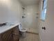 Bathroom features tiled shower with shampoo shelves, modern vanity, and ceramic floors at 3576 Pinehill Cir, Acworth, GA 30101