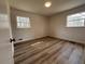 Bright bedroom with neutral walls, hardwood floors, and two windows offering natural light at 3576 Pinehill Cir, Acworth, GA 30101