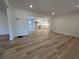 Open concept living room featuring hardwood floors flowing into the kitchen space with bright white walls and recessed lights at 3576 Pinehill Cir, Acworth, GA 30101