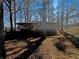 Back of a brick home with a wooden deck overlooking a yard covered in leaves at 4227 Pine Cir, Forest Park, GA 30297