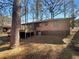 Backyard view of house with deck featuring brick and dark brown siding at 4227 Pine Cir, Forest Park, GA 30297