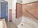 Bathroom with tiled walls, built-in tub, and updated fixtures at 4227 Pine Cir, Forest Park, GA 30297