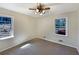 Cozy bedroom with neutral walls, carpet, and natural light from the windows at 4227 Pine Cir, Forest Park, GA 30297