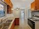 Galley kitchen with vintage cabinetry, stainless steel sink, and gas range at 4227 Pine Cir, Forest Park, GA 30297