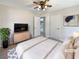 Staged main bedroom with natural light, carpeted floor, and a view into the living area at 4227 Pine Cir, Forest Park, GA 30297