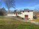 Two-story home featuring a white exterior, backyard, and gravel driveway at 1376 Cornwall Rd, Decatur, GA 30032