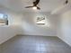 This empty bedroom offers tile flooring, a ceiling fan, and great natural light from the windows at 1376 Cornwall Rd, Decatur, GA 30032