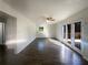 Bright living room features wood-look flooring, a ceiling fan, and sliding doors to the backyard at 1376 Cornwall Rd, Decatur, GA 30032