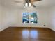 Bright, empty living room space with large windows and hardwood floors at 1376 Cornwall Rd, Decatur, GA 30032