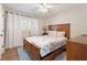 Bright bedroom showcasing hardwood floors, natural light, a ceiling fan, and neutral-toned walls at 1915 Pine Rd, Dacula, GA 30019