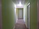 Long hallway with carpet and multiple doors, providing access to different rooms at 1975 Lily Stem Trl, Auburn, GA 30011