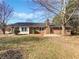 Backyard of brick home with a well-manicured lawn and patio area at 2622 Abington Dr, Snellville, GA 30078