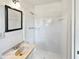 Cozy bathroom featuring a stand up shower, neutral sink, and a vanity mirror at 2622 Abington Dr, Snellville, GA 30078