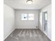 An airy bedroom with neutral carpet and a large window providing ample natural light at 2622 Abington Dr, Snellville, GA 30078
