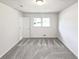 An airy bedroom with neutral carpet and a large window providing ample natural light at 2622 Abington Dr, Snellville, GA 30078