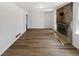 Bright living room featuring a brick fireplace and wood flooring at 2622 Abington Dr, Snellville, GA 30078