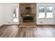 Inviting living room featuring a brick fireplace and new hardwood floors with access to the backyard at 2622 Abington Dr, Snellville, GA 30078