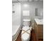 Clean bathroom featuring a shower, toilet and sink with neutral tones at 1302 Milstead Ne Trce, Marietta, GA 30066