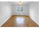 Dining room with chair rail, wood floors, a chandelier, and a large window at 1302 Milstead Ne Trce, Marietta, GA 30066