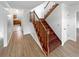 Inviting foyer with wood staircase and hardwood floors, leading to the kitchen at 1302 Milstead Ne Trce, Marietta, GA 30066