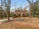 Charming two-story brick home featuring a manicured front lawn with mature trees at 1302 Milstead Ne Trce, Marietta, GA 30066