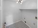 Laundry room with black-and-white patterned tile and white walls and trim at 1302 Milstead Ne Trce, Marietta, GA 30066