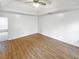 Main bedroom featuring tray ceilings, wood floors, and neutral walls at 1302 Milstead Ne Trce, Marietta, GA 30066