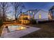 Inviting backyard pool area with a stone patio, manicured lawn and string lights, perfect for evening relaxation at 1537 Harts Mill Ne Rd, Brookhaven, GA 30319