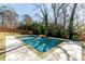 Backyard swimming pool featuring a waterfall feature and a beautiful stone patio at 1537 Harts Mill Ne Rd, Brookhaven, GA 30319