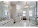 Bright bathroom featuring double vanity sinks, marble countertops, and a luxurious soaking tub at 1537 Harts Mill Ne Rd, Brookhaven, GA 30319