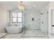 Bright bathroom with marble walk-in shower, soaking tub, and window view at 1537 Harts Mill Ne Rd, Brookhaven, GA 30319