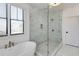 Bright bathroom with marble walk-in shower, soaking tub, and window view at 1537 Harts Mill Ne Rd, Brookhaven, GA 30319
