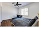 Simple bedroom featuring a ceiling fan, dark wood floors, and a gray comforter at 1537 Harts Mill Ne Rd, Brookhaven, GA 30319
