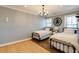 Neutral guest bedroom with twin beds, a classic chandelier, and natural light from the two sunny windows at 1537 Harts Mill Ne Rd, Brookhaven, GA 30319