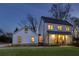 Charming two-story home with warm lighting and well-manicured lawn at twilight at 1537 Harts Mill Ne Rd, Brookhaven, GA 30319