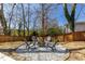 Backyard fire pit area featuring gravel, chairs, and a cozy ambiance for outdoor gatherings at 1537 Harts Mill Ne Rd, Brookhaven, GA 30319