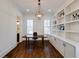 Bright home office with built-in bookshelves, hardwood floors, and a view of the neighborhood at 1537 Harts Mill Ne Rd, Brookhaven, GA 30319