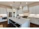 Bright kitchen with white cabinets, stainless appliances, large island, and sleek white countertops at 1537 Harts Mill Ne Rd, Brookhaven, GA 30319