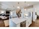 Open-concept kitchen with a large island, stainless steel appliances, and stylish pendant lighting at 1537 Harts Mill Ne Rd, Brookhaven, GA 30319