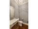 Elegant powder room featuring a stylish vanity, mirrored accents, and modern fixtures at 1537 Harts Mill Ne Rd, Brookhaven, GA 30319