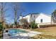 Rear exterior view of a white house with a screened porch and a swimming pool, perfect for relaxation at 1537 Harts Mill Ne Rd, Brookhaven, GA 30319