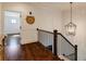 Upstairs hallway with hardwood floors and a stylish pendant light fixture at 1537 Harts Mill Ne Rd, Brookhaven, GA 30319