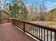 Spacious wooden deck with scenic views of the surrounding trees and landscape at 1100 Cotton Gin Dr, Woodstock, GA 30188
