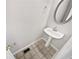 A well lit half bathroom contains a pedestal sink, decorative mirror and tile flooring at 1100 Cotton Gin Dr, Woodstock, GA 30188