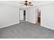 Spacious main bedroom with gray carpet, ceiling fan, walk-in closet and ensuite bathroom at 1100 Cotton Gin Dr, Woodstock, GA 30188